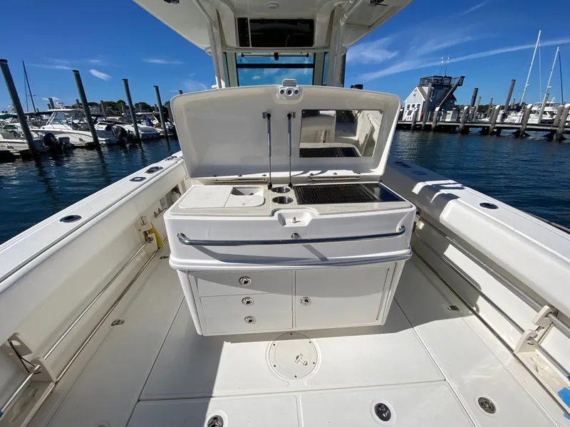 Slide: The Image of 2014 Boston Whaler 320 Outrage with open workstation at the marina. - 7