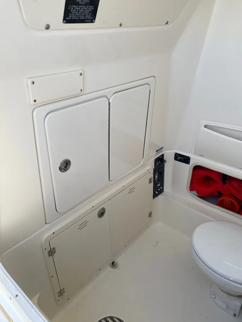 Slide: The Image of Interior of 2014 Boston Whaler 320 Outrage with storage and toilet. - 9