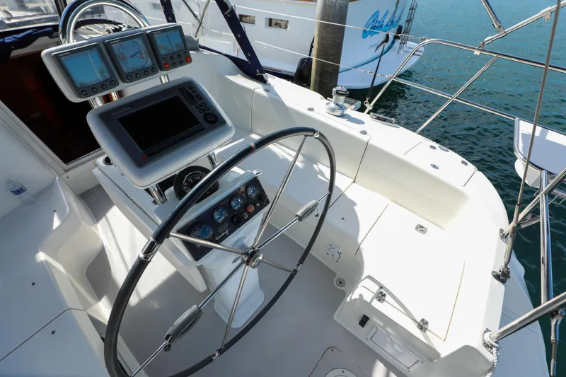 Slide: The Image of Cockpit of 2010 Catalina 375 sailboat with steering wheel and navigation instruments. - 11