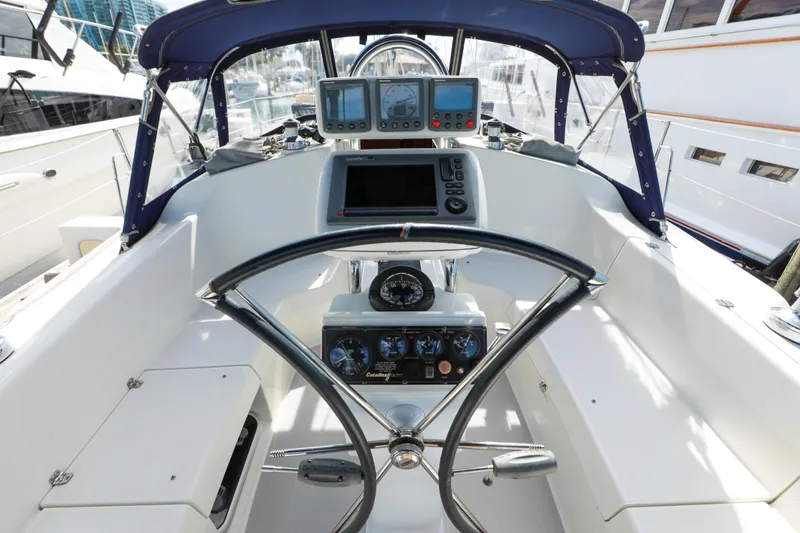Slide: The Image of Cockpit of a 2010 Catalina 375 sailboat with navigation instruments and steering wheel. - 24
