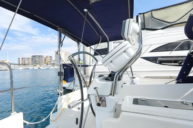Slide: The Image of Cockpit view of 2010 Catalina 375 sailboat docked in marina with cityscape background. - 25