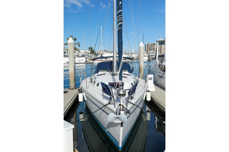 Slide: The Image of 2010 Catalina 375 sailboat docked at marina under clear blue sky. - 27