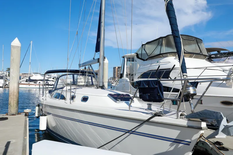 Slide: The Image of Catalina 375 sailboat docked at marina, 2010 model, under clear blue sky. - 3