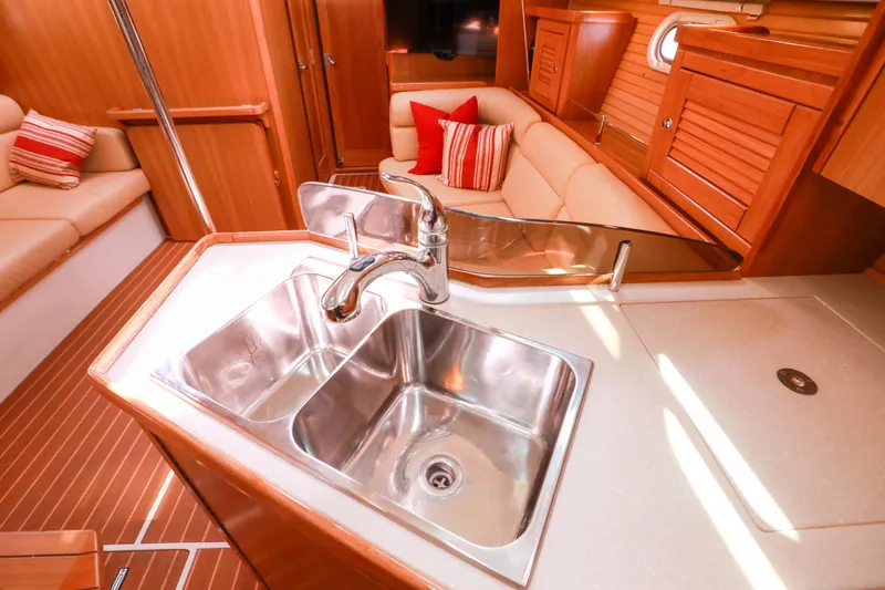 Slide: The Image of Luxurious interior of 2010 Catalina 375 yacht featuring a modern kitchen sink and cozy seating area. - 38