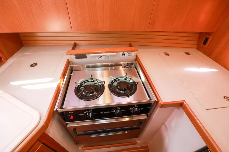 Slide: The Image of Catalina 375 2010 yacht kitchen with stainless steel stove and wooden cabinetry. - 39