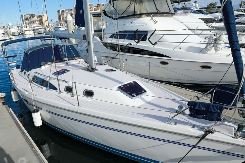 Slide: The Image of 2010 Catalina 375 sailboat docked at marina, surrounded by other boats. - 4