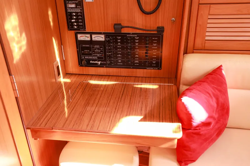 Slide: The Image of Interior of 2010 Catalina 375 yacht with control panel and wooden table. - 42