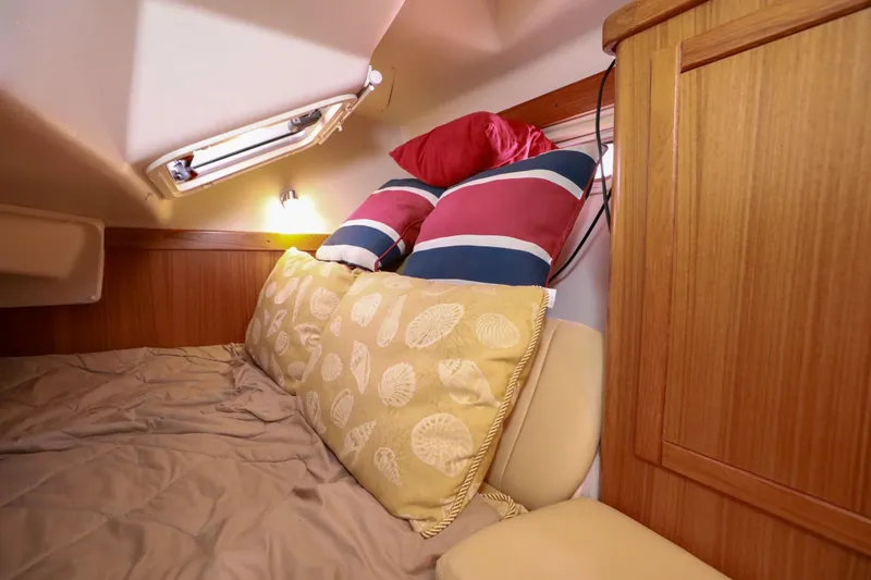 Slide: The Image of Cozy cabin interior of 2010 Catalina 375 sailboat with pillows and wooden paneling. - 43