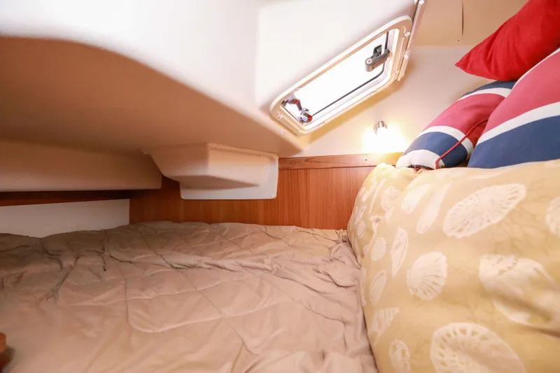 Slide: The Image of Cozy cabin interior of 2010 Catalina 375 sailboat with bedding and porthole. - 44