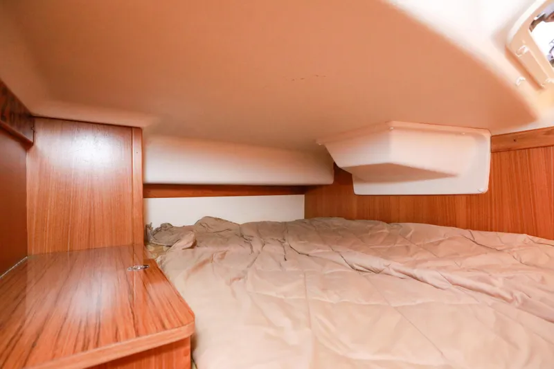 Slide: The Image of Cozy cabin interior of 2010 Catalina 375 sailboat with wood paneling and bedding. - 45