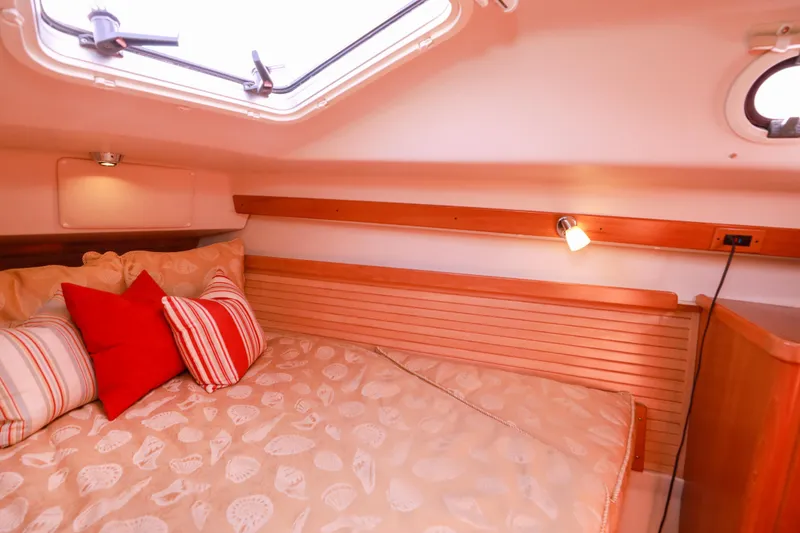 Slide: The Image of Cozy cabin interior of 2010 Catalina 375 sailboat with decorative pillows and soft lighting. - 48