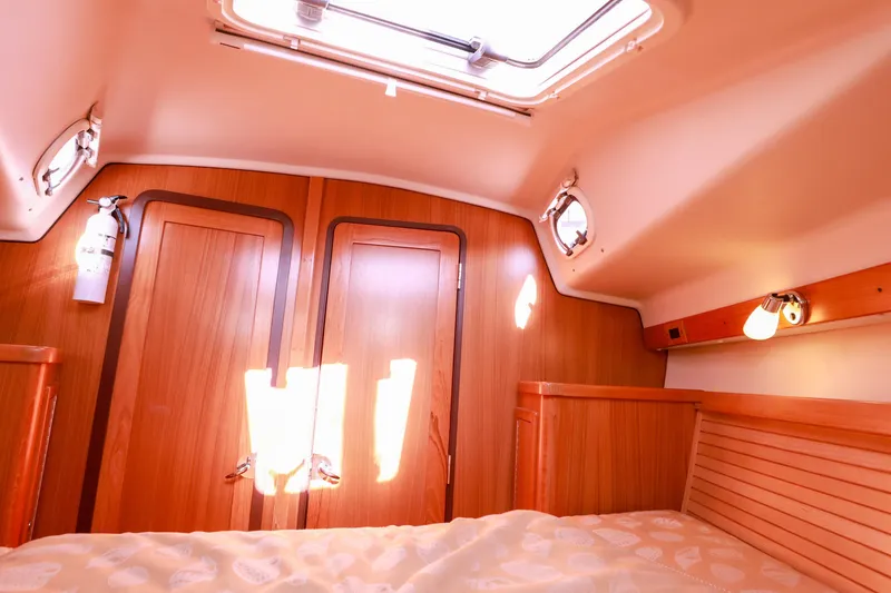 Slide: The Image of Cozy cabin interior of 2010 Catalina 375 sailboat with wooden finish and natural light. - 49