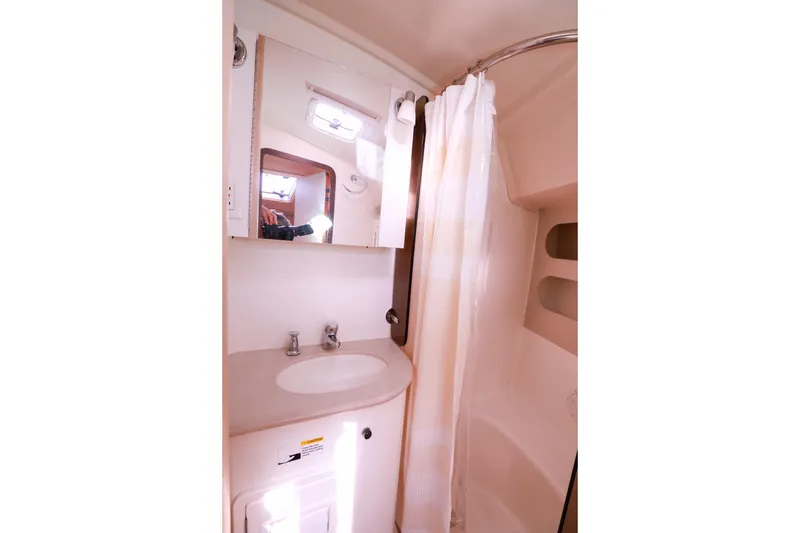 Slide: The Image of Bathroom interior of 2010 Catalina 375 yacht with sink, mirror, and shower curtain. - 52