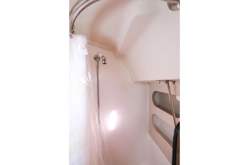 Slide: The Image of Shower area in 2010 Catalina 375 sailboat with curtain and built-in shelves. - 53