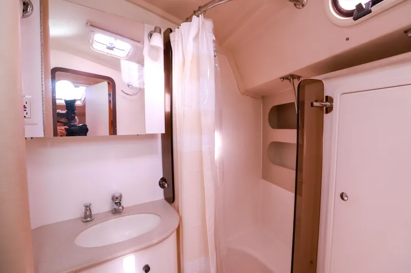 Slide: The Image of Bathroom interior of 2010 Catalina 375 yacht, featuring sink, mirror, and shower area. - 54