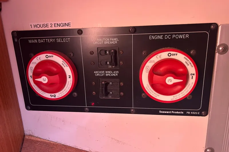 Slide: The Image of Control panel of a 2010 Catalina 375 sailboat with battery selectors and circuit breakers. - 62