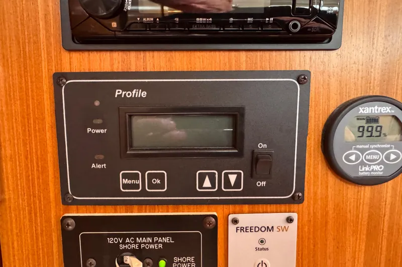 Slide: The Image of Control panel of a 2010 Catalina 375 sailboat with battery monitor and power switches. - 68