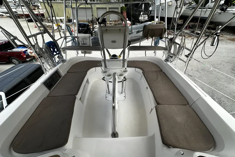 Slide: The Image of 2004 Hunter 41 Aft Cockpit sailboat with spacious seating and helm, docked in a marina. - 10