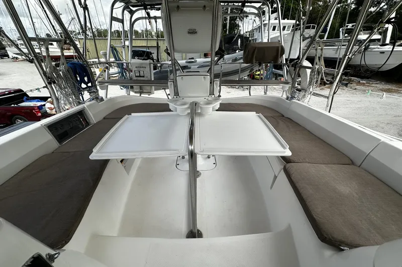 Slide: The Image of 2004 Hunter 41 Aft Cockpit sailboat interior with cushioned seating and foldable table. - 11