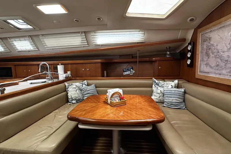 Slide: The Image of Luxurious interior of 2004 Hunter 41 Aft Cockpit sailboat with cozy seating and wooden table. - 15