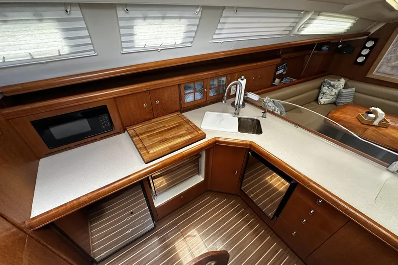 Slide: The Image of Luxurious 2004 Hunter 41 Aft Cockpit yacht interior with modern kitchen and cozy seating area. - 17