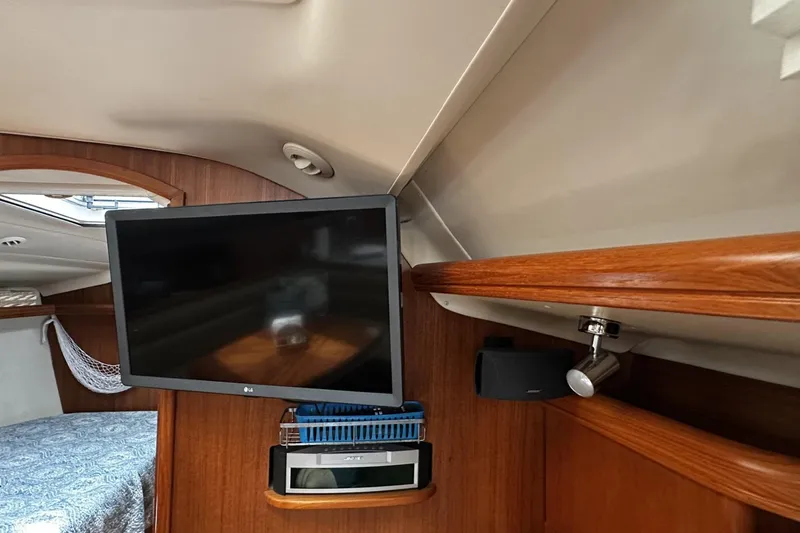 Slide: The Image of Interior of 2004 Hunter 41 Aft Cockpit yacht with TV and wooden finish. - 20