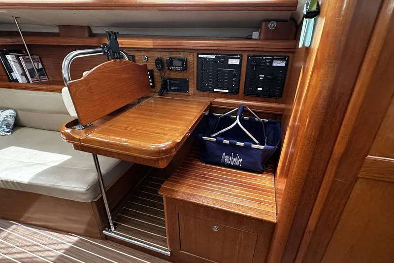 Slide: The Image of Interior of 2004 Hunter 41 Aft Cockpit yacht with navigation station and wooden finish. - 21