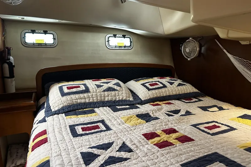 Slide: The Image of Cozy cabin interior of 2004 Hunter 41 Aft Cockpit with nautical-themed bedding. - 25