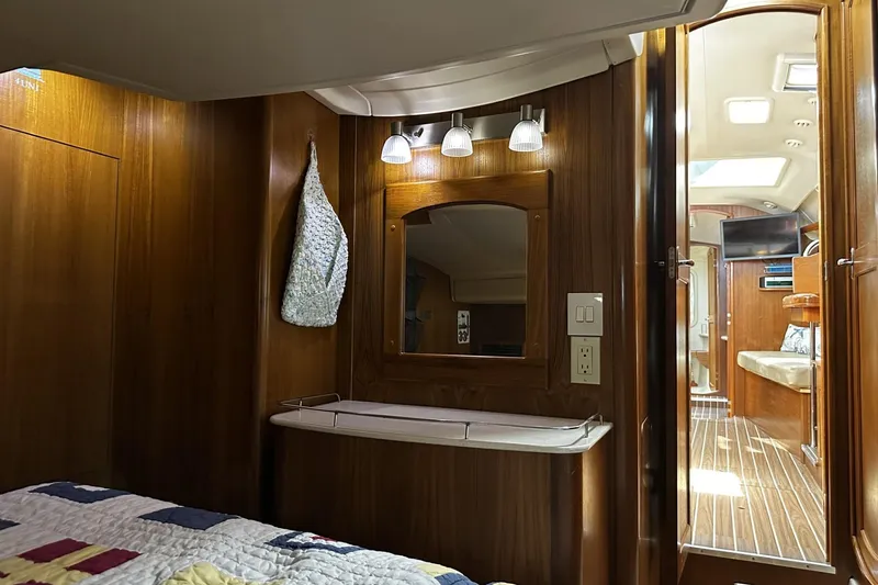 Slide: The Image of Interior of 2004 Hunter 41 Aft Cockpit yacht with wood paneling and cozy cabin. - 27