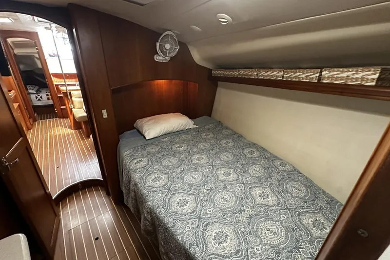 Slide: The Image of Cozy cabin interior of 2004 Hunter 41 Aft Cockpit sailboat with patterned bedding. - 30