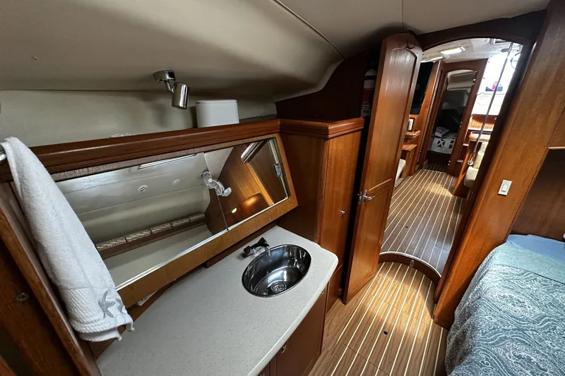 Slide: The Image of Interior of 2004 Hunter 41 Aft Cockpit yacht with wood finish and compact bathroom. - 31