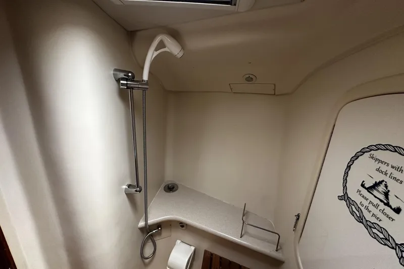 Slide: The Image of Compact bathroom in 2004 Hunter 41 Aft Cockpit yacht with shower and nautical decor. - 34