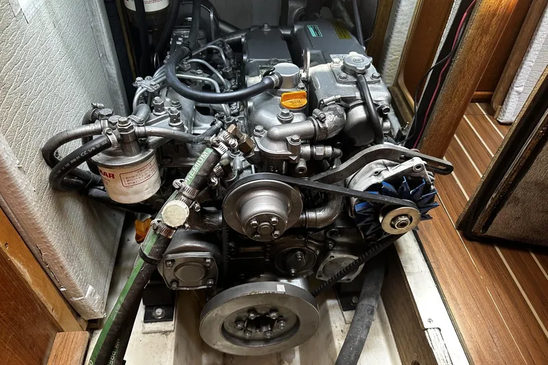 Slide: The Image of Engine compartment of a 2004 Hunter 41 Aft Cockpit sailboat, showcasing detailed mechanical components. - 35