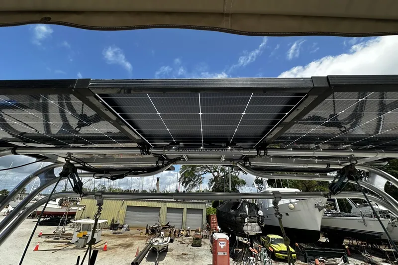 Slide: The Image of Solar panels on a 2004 Hunter 41 Aft Cockpit sailboat under a clear blue sky. - 41