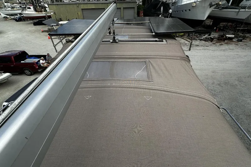 Slide: The Image of 2004 Hunter 41 Aft Cockpit sailboat with solar panels, docked in a boatyard. - 42
