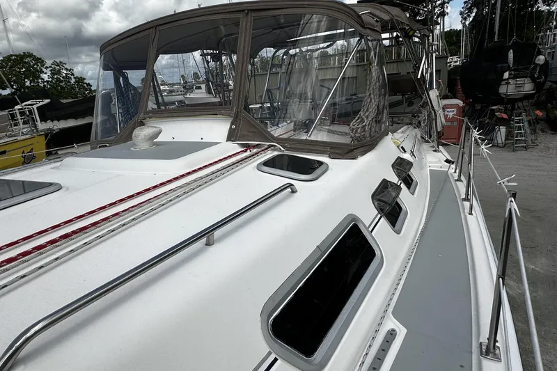 Slide: The Image of 2004 Hunter 41 Aft Cockpit sailboat with covered cockpit, docked in a marina. - 43