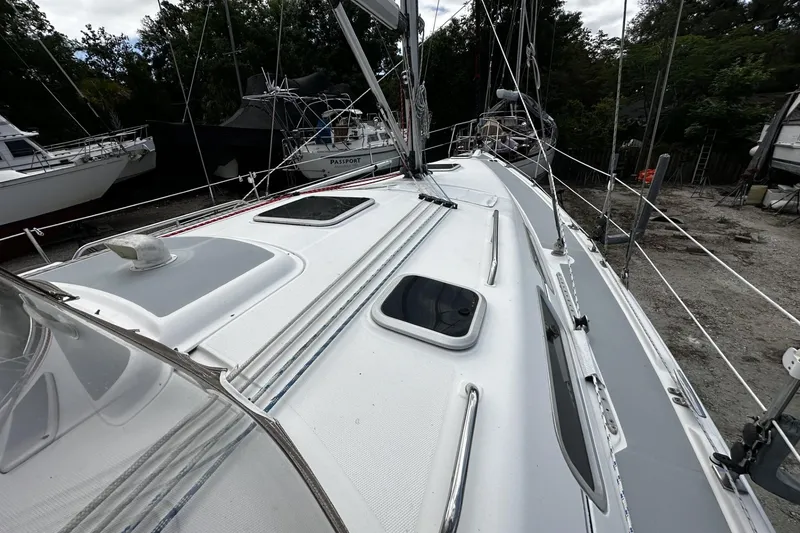 Slide: The Image of 2004 Hunter 41 Aft Cockpit sailboat on land, showcasing deck and rigging. - 44