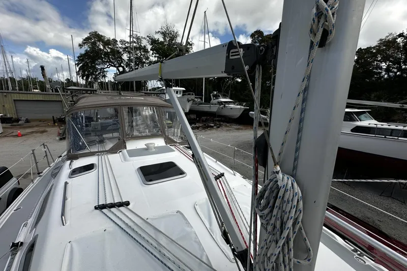 Slide: The Image of 2004 Hunter 41 Aft Cockpit sailboat on land, surrounded by other boats. - 51
