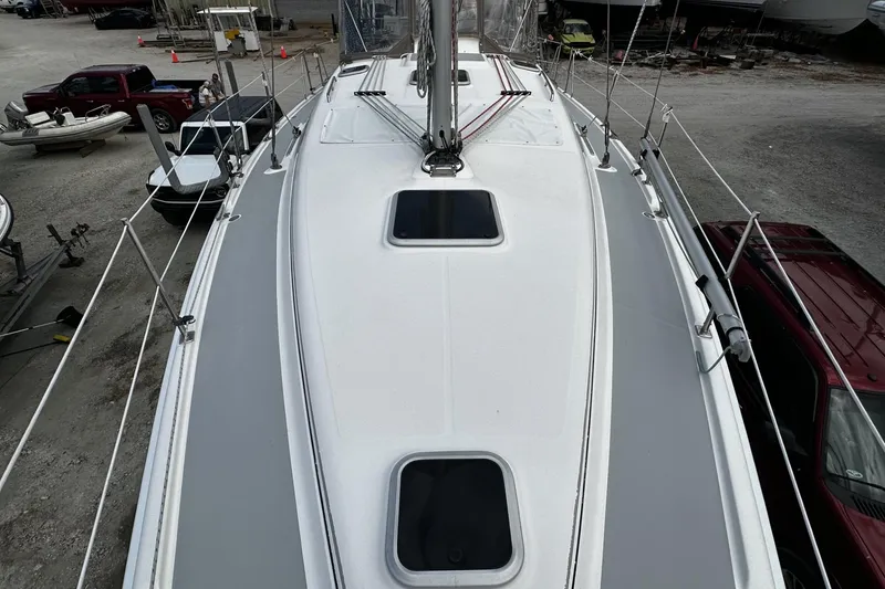 Slide: The Image of 2004 Hunter 41 Aft Cockpit sailboat deck view in a marina setting. - 6