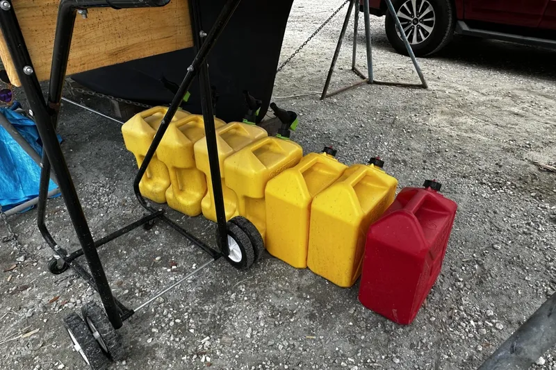 Slide: The Image of Yellow and red fuel containers beside a Hunter 41 Aft Cockpit, 2004 model. - 61