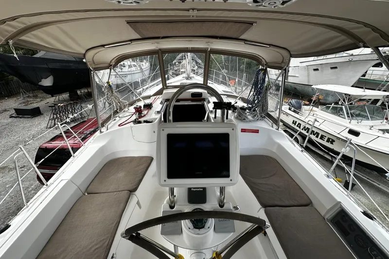 Slide: The Image of 2004 Hunter 41 Aft Cockpit sailboat interior with navigation equipment and seating. - 8