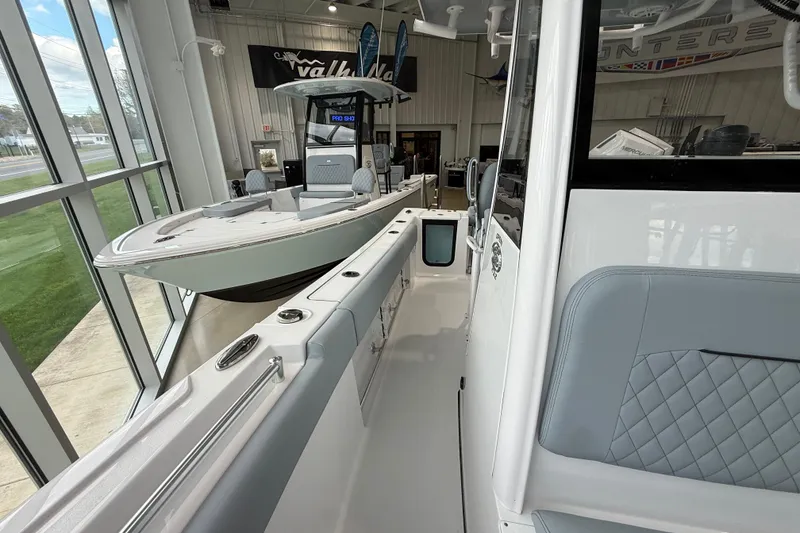 Slide: The Image of 2026 Sportsman Open 232 Center Console boat displayed in a showroom. - 10
