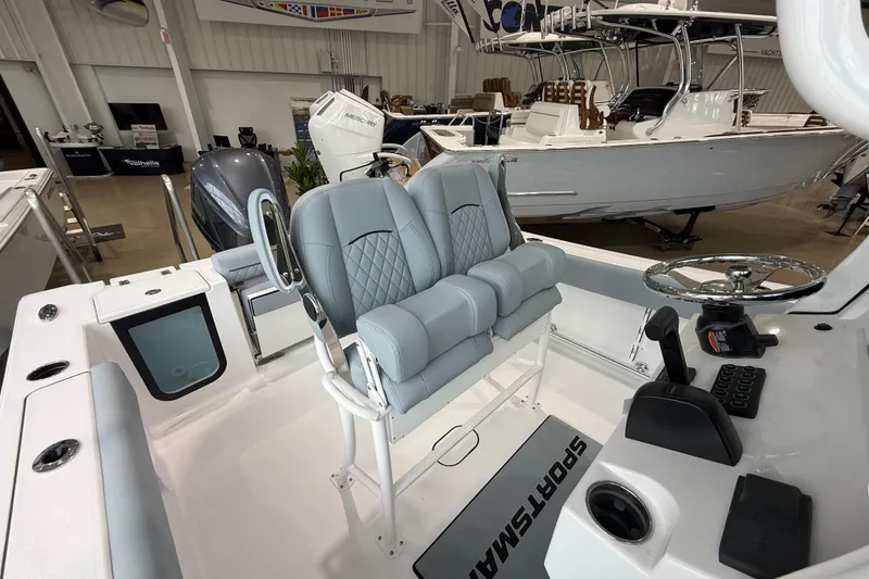 Slide: The Image of 2026 Sportsman Open 232 Center Console boat interior with dual seats and steering wheel. - 11