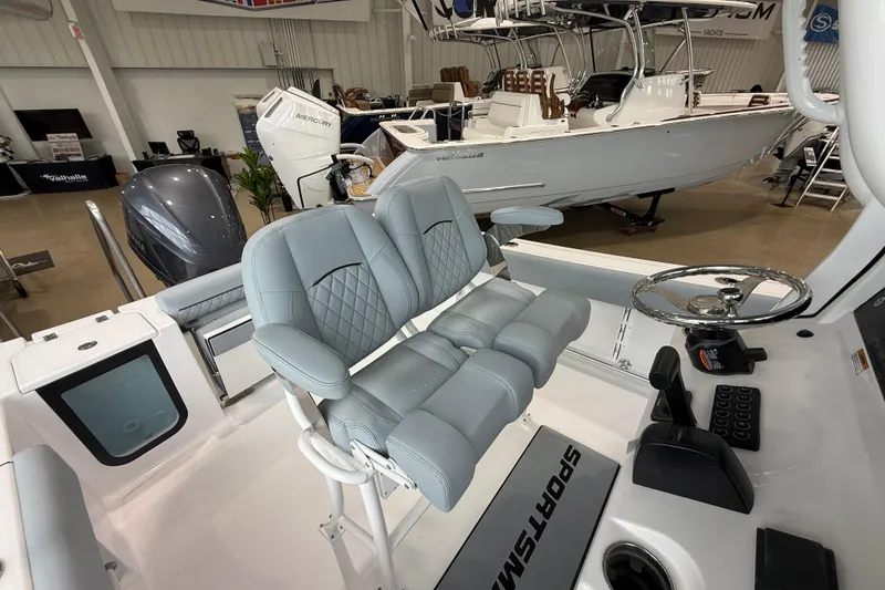 Slide: The Image of 2026 Sportsman Open 232 Center Console boat interior with dual seating and steering wheel. - 12