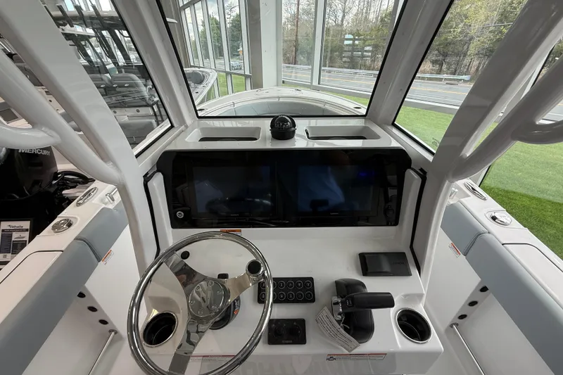 Slide: The Image of 2026 Sportsman Open 232 Center Console helm with dual screens and modern controls. - 13