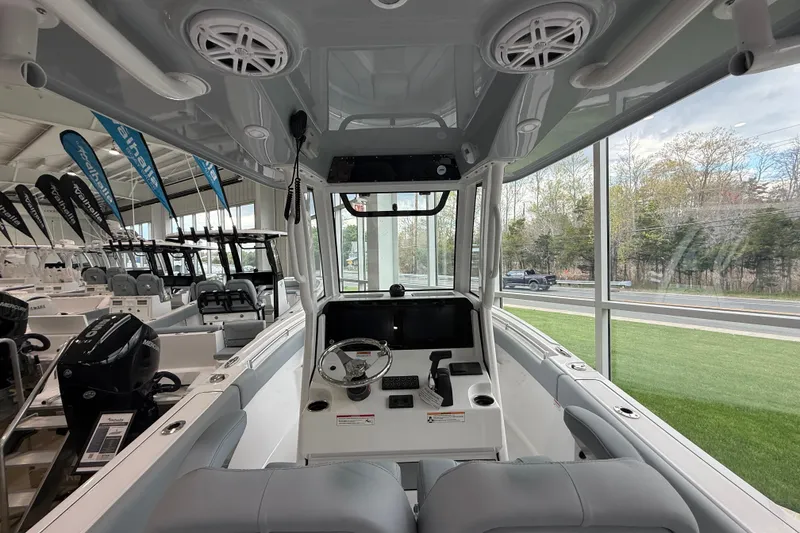 Slide: The Image of 2026 Sportsman Open 232 Center Console boat interior with modern dashboard and seating. - 15