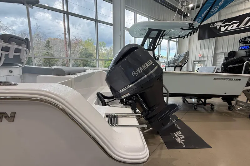 Slide: The Image of 2026 Sportsman Open 232 Center Console boat with Yamaha outboard motor in showroom. - 3