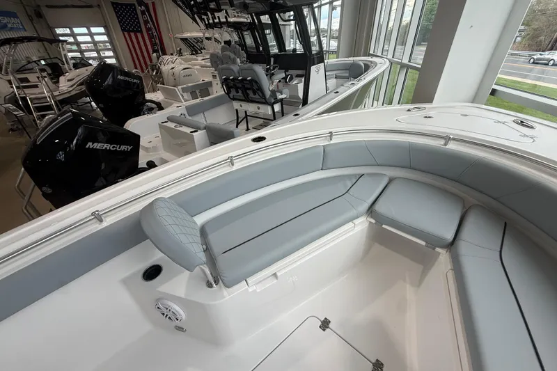 Slide: The Image of 2026 Sportsman Open 232 Center Console boat interior with seating and Mercury engines. - 7