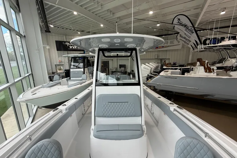 Slide: The Image of 2026 Sportsman Open 232 Center Console boat displayed in a showroom. - 8