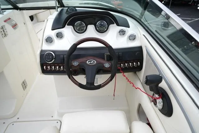 Slide: The Image of 2007 Sea Ray SLX 250 boat dashboard with steering wheel and control panel. - 10